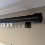 Black curtain rod mounted on a white wall Chanel rod drapery hardware, black rod, black track