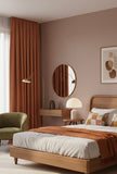 Modern bedroom with wooden bed, round mirror, and brown curtains.Orange pinch pleated curtains.blackout fabric