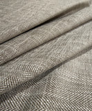 Double-sided taupe chenille herringbone upholstery and drapery fabric with a soft textured weave.