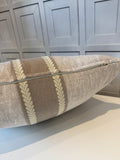 Textured pillow with decorative pattern against a neutral wall.
Zipper in cushion cover
