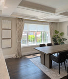 custom window treatment Modern dining room with a large window, wooden table, and chairs.