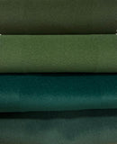 Stack of green fabric swatches with different textures