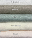 Stack of textured fabric swatches labeled 'Soft White', 'Vapour', 'Chic', 'Buttermilk', and 'Blush'. 
Boucle Fabrics in white, natural, blush pink, tile, pastel colours.