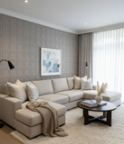 Modern living room with a beige sectional sofa, decorative pillows, and a coffee table.